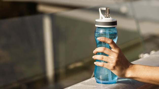 close-up-hand-holding-water-bottle_23-2148759051