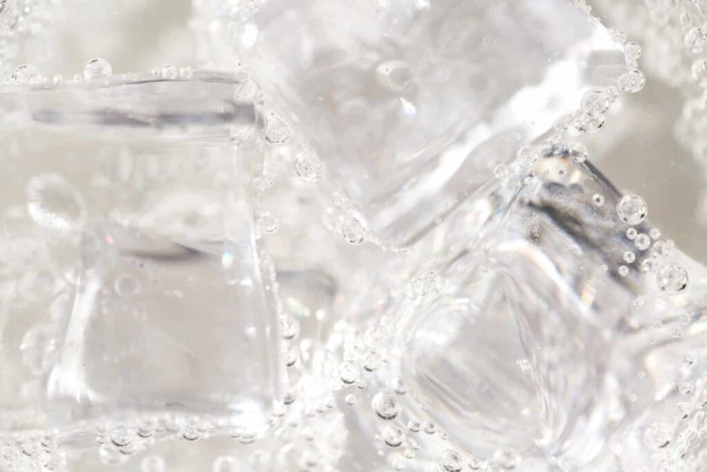 clear glass container on white textile