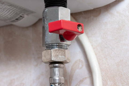 Red metal sanitary valve that provides hot water supply from a water heater, boiler.